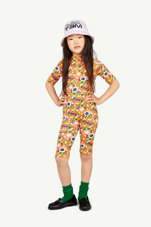 Image featuring a girl wearing a floral jumpsuit by The Animals Observatory. The image shows the front of the jumpsuit.